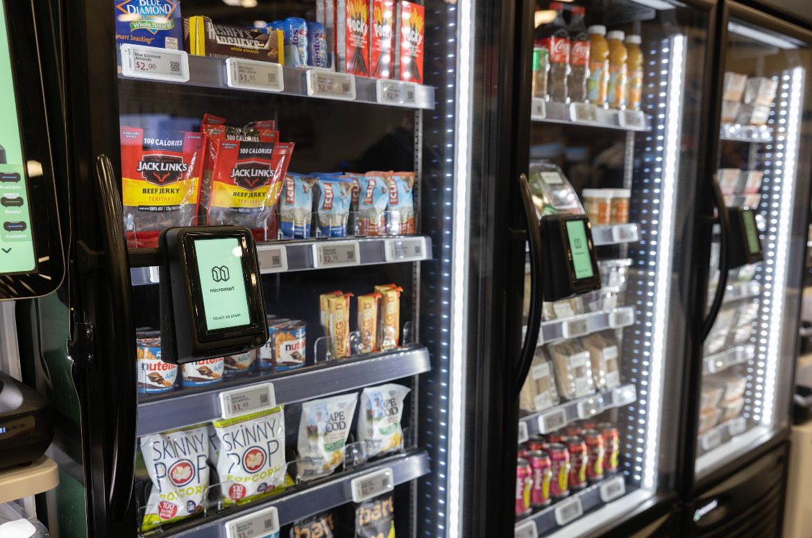Example micro-market with stocked coolers and self-checkout hardware.